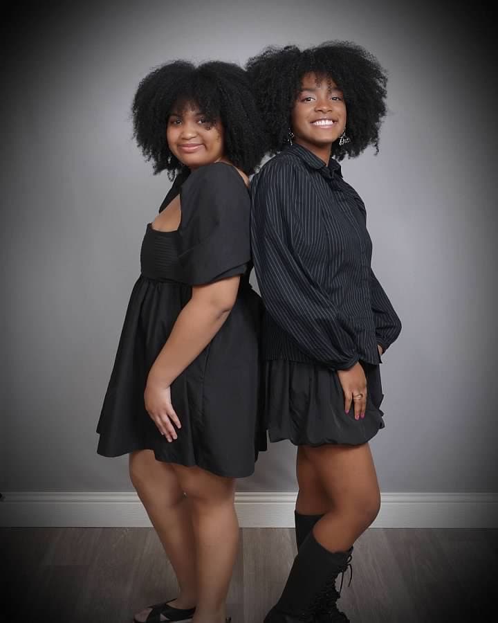Two beautiful young African American sisters walking